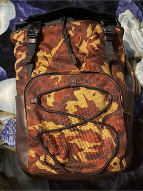 coach backpack camouflage League Flap in Signature with Camo Print Leather Signature coated canvas and smooth calf leather Two separate main compartments with zip closures Inside zip cell phone and multifunction pockets Fabric lining Top handle with 3 1/4 drop Outside zip pocket Adjustable shoulder straps 12 1/2 (L) x 16 3/4 (H) x 6 (W) Style No. Coach | Bags | Nwt